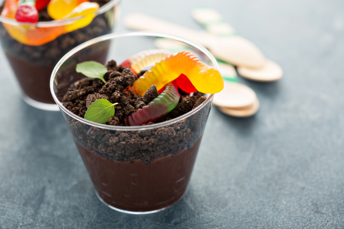 Children chocolate dessert in a cup dirt and worms